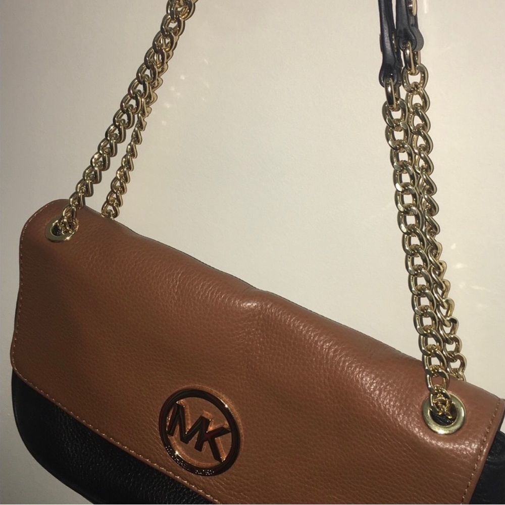 Gold strap and lettering. Black and brown leather MK purse.